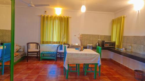 a dining room with a table and some chairs at The Nagri Resort in Pālampur