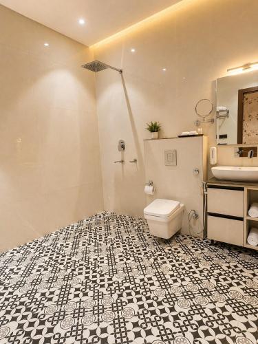 a bathroom with a toilet and a sink at Hotel Sunshine in Surajpur Jikkla