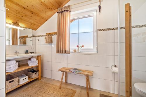 a bathroom with a toilet and a sink and a window at Ferienhaus Geyerbad mit Sauna in Meßstetten