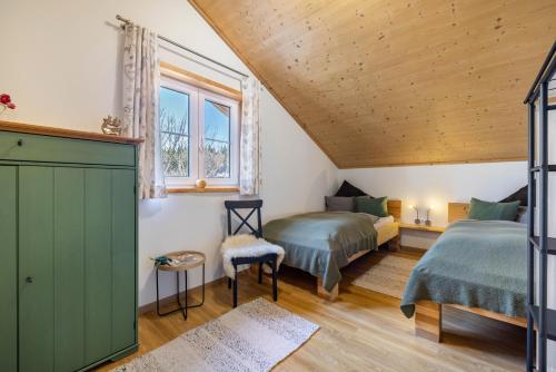 a bedroom with two beds and a window at Ferienhaus Eichenstein in Meßstetten