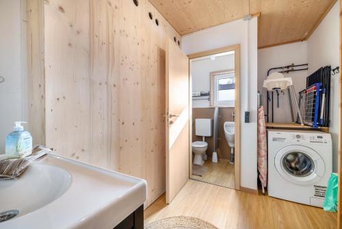 a bathroom with a sink and a washing machine at Ferienhaus Eichenstein in Meßstetten