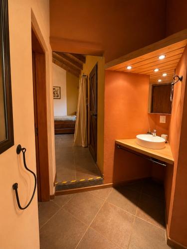 a bathroom with a sink and a shower at Cabañas La Matera Apart in Los Reartes