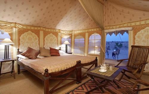 a bedroom with a bed in a room at MANVĀR SEVAN, THE DESERT CAMP in Shaitrāwa