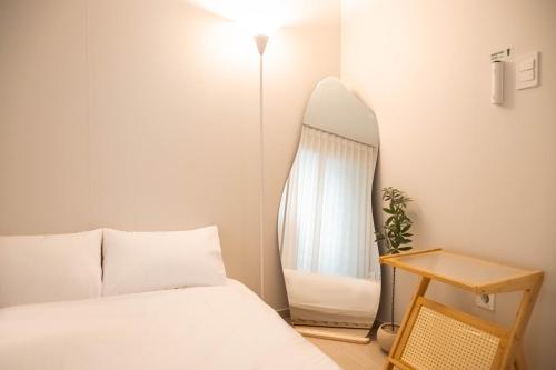a bedroom with a bed and a mirror at 가치스테이 강서 in Seoul