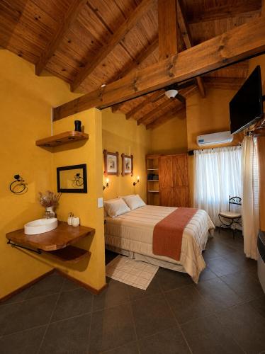 a bedroom with a bed and a television in a room at Cabañas La Matera Apart in Los Reartes