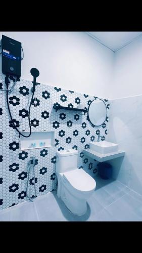 a bathroom with a toilet and a mirror at Rainbow River View in Jerantut