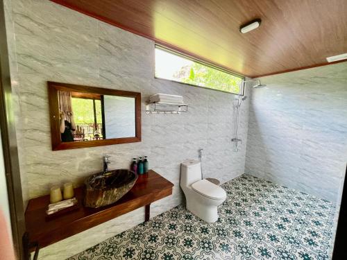 a bathroom with a sink and a toilet at Peaceful Garden Tam Cốc in Ninh Binh