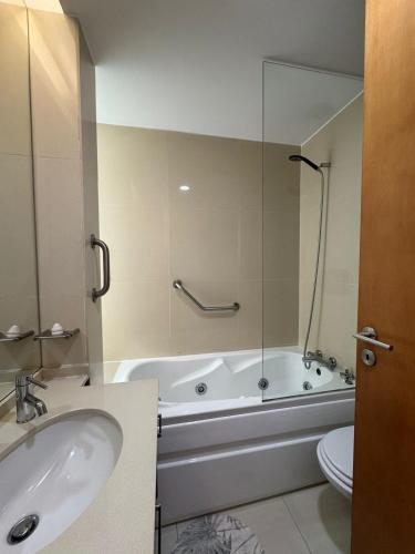 a bathroom with a tub and a sink and a toilet at Beach House - Aguda Beach - 2 bedrooms in Arcozelo