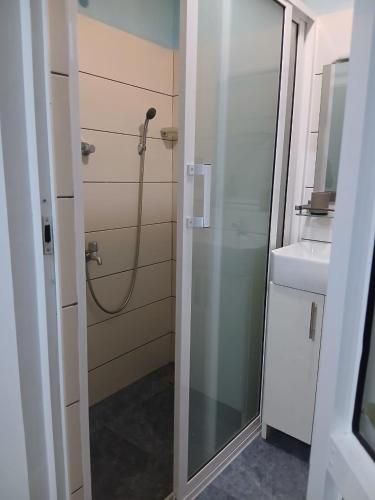 a bathroom with a shower and a sink at Avona Villa in Bopitiya
