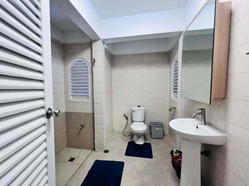 a bathroom with a white toilet and a sink at Villa Wongamat in North Pattaya