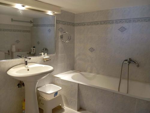 a bathroom with a sink and a toilet and a bath tub at Maria Apostolou villa in Almiros
