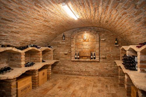 a wine tasting room with a brick wall at Boutique Hotel at Golf Piestany in Piešťany
