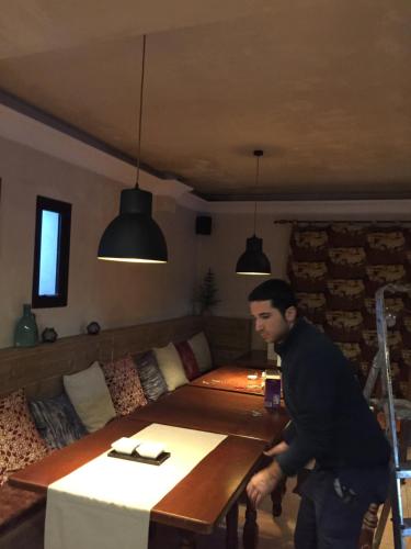 a man standing in front of a table in a living room at Al Lago in Zahara de la Sierra