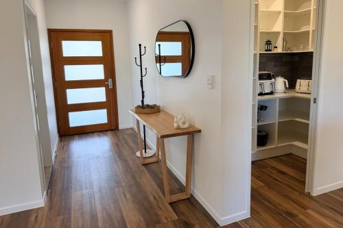 a hallway with a table and a mirror at The Village HQ in Yungaburra