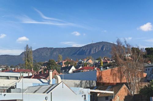 a small town with mountains in the background at Hobart CBD Loft - Walking to CBD in Hobart