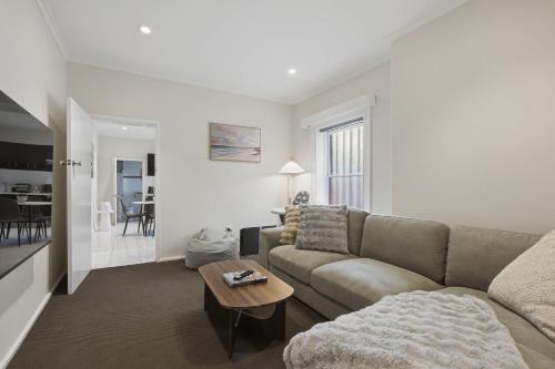 a living room with a couch and a table at Hobart CBD Loft - Walking to CBD in Hobart