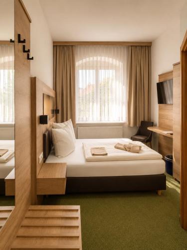 a hotel room with a bed and a window at Pension am Markt in Wurzen