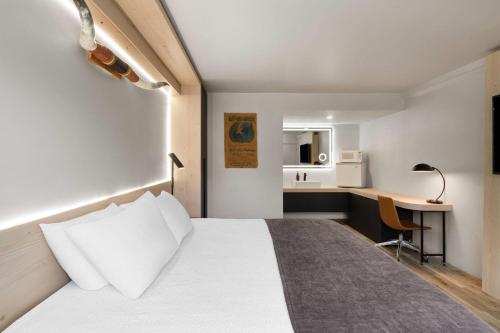 a hotel room with a bed and a desk at The Hotel Pendleton, Trademark Collection by Wyndham in Pendleton