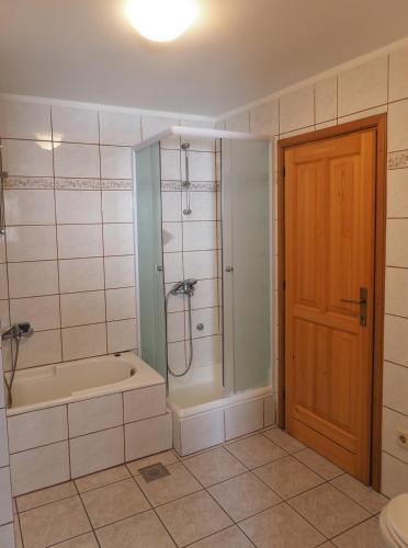 a bathroom with a shower and a tub and a toilet at Apartman Seven Waves in Punat