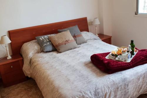 a bed with a tray of food on top of it at Mediterranean Apartment with WIFI in Canet de Berenguer