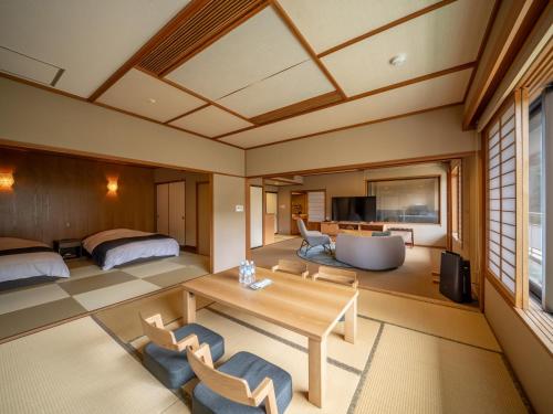 a japanese suite with a bedroom and a living room at Kinugawa Hotel Mikazuki in Nikko