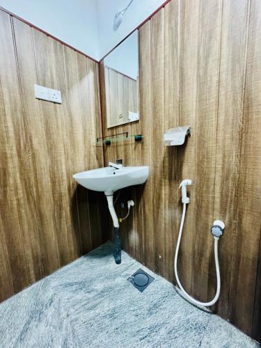 a bathroom with a sink and a mirror at Friendly Waves Resort Arugambay in Pottuvil