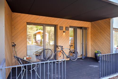 a bike parked on the porch of a house at Albatross Home in Ķesterciems