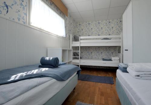 a bedroom with two beds and a window at LelleBlue Vendégház in Balatonlelle