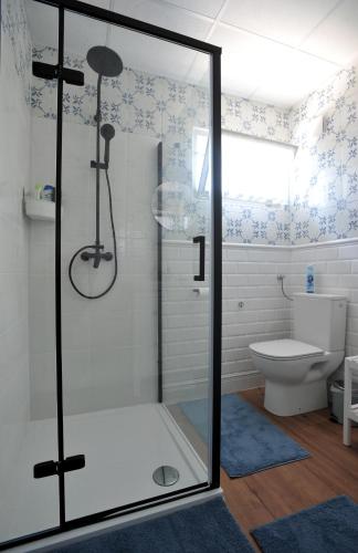 a bathroom with a shower and a toilet at LelleBlue Vendégház in Balatonlelle