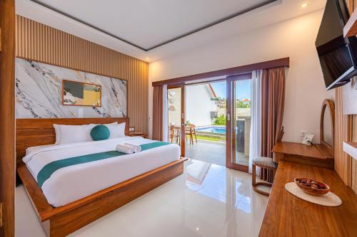 a bedroom with a large bed and a balcony at Cove Tegeh Bila in Ungasan