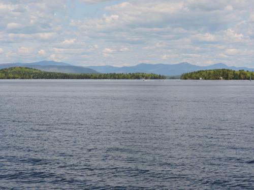 a view of the water with mountains in the background at Belknap Point Inn in Gilford