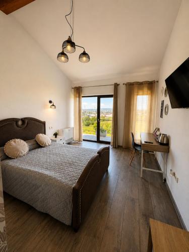 a bedroom with a bed and a desk and a window at Hill House in Drobeta-Turnu Severin