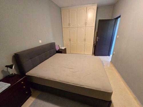 a small bedroom with a bed and a closet at Patras Ressort in Patra