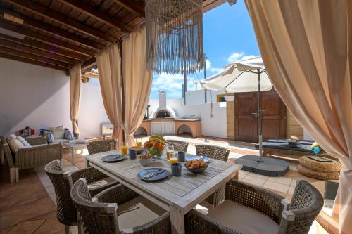 a dining room with a table and chairs and a kitchen at Casa Aestas in Lachania
