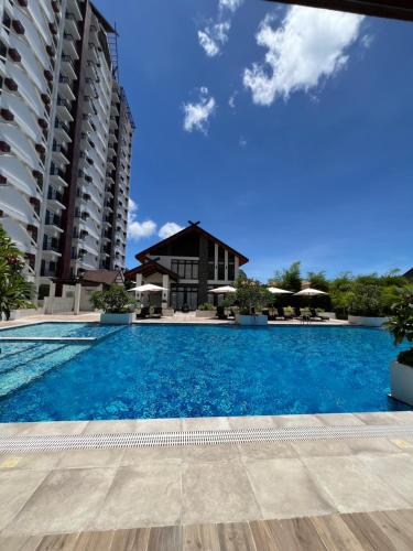 a large swimming pool in front of a building at Royal Oceancrest Eleanor suites in Lapu Lapu City