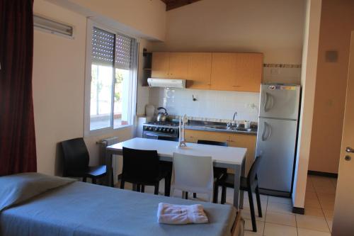 a kitchen with a table and a kitchen with a refrigerator at Bet Hotel Buenos Aires in Buenos Aires