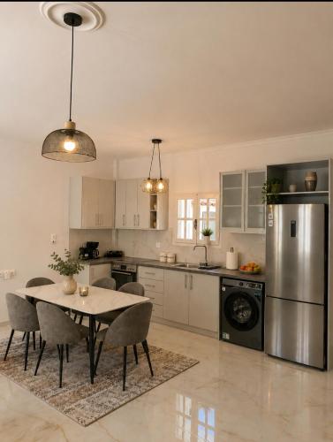 a kitchen with a table and chairs in it at Villa Harmonia I -Elegant Retreat in Karlovasi