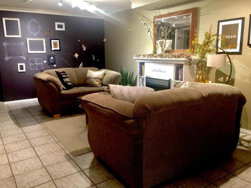 a living room with two couches and a fireplace at Evergreen Bed & Breakfast in Hope