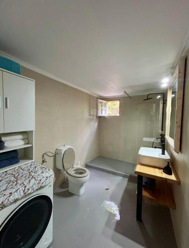 a small bathroom with a toilet and a sink at Stone & Sea Retreat in Órmos Marathokámpou
