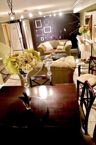 a living room with a couch and a table with flowers at Evergreen Bed & Breakfast in Hope