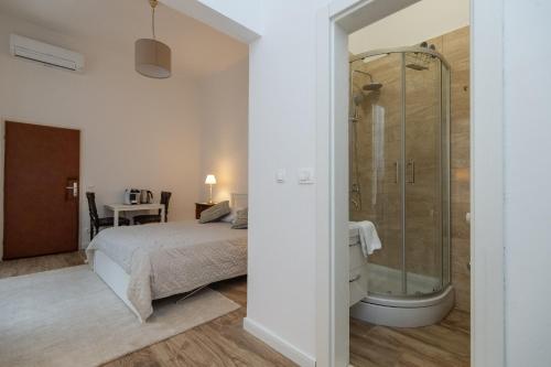 a bedroom with a shower and a bed at Apartment and Rooms Stay in Dubrovnik