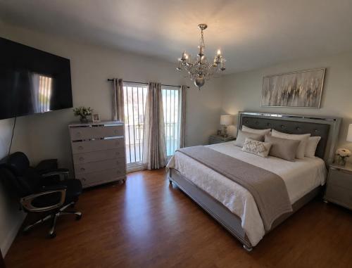 a bedroom with a bed and a chair and a chandelier at Oceanview house in El Suazal