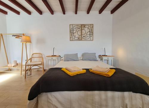 a bedroom with a bed with two towels on it at LUANA APARTMENT in Teguise