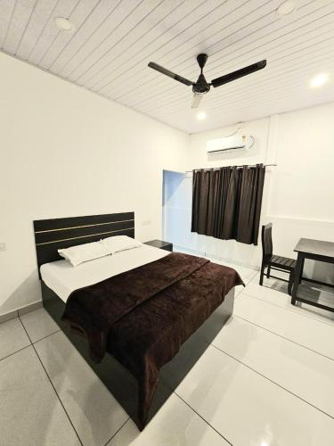 a bedroom with a large bed and a table at Thekkady Nest Residency in Thekkady