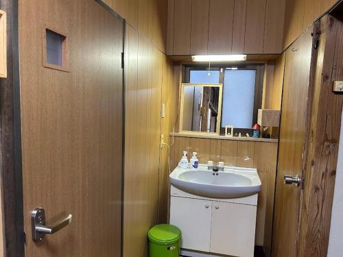 a bathroom with a sink and a mirror at YADOease in Tsuiki
