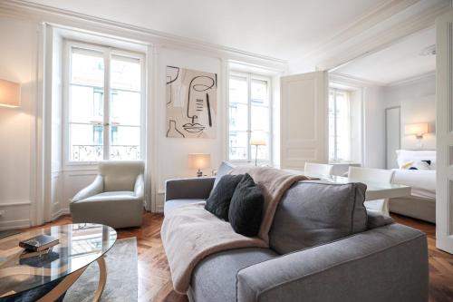 a living room with a couch and a bed at Swiss Luxury Apartments Geneva - Serviced Apartments in Geneva