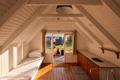 a room with two beds and a person in the doorway at Fårup Skovbrynet in Saltum