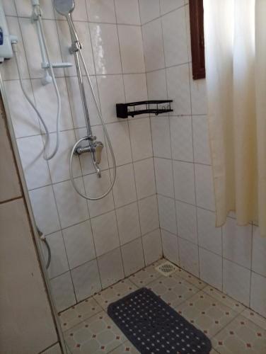 a bathroom with a shower with a black mat at Spring homes2 in Jinja