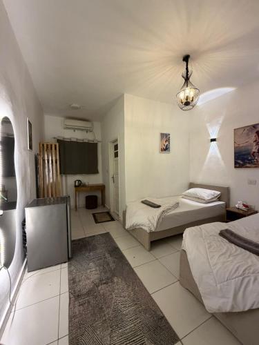a bedroom with two beds and a chandelier at Antika Hotel in Dahab