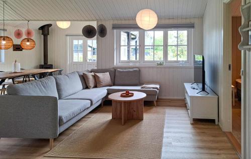 a living room with a couch and a table at Awesome Home In Hurup Thy With Wifi in Sønder Ydby